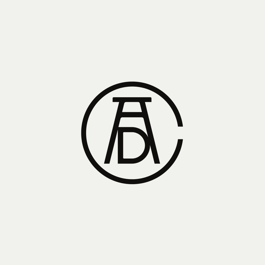 Art Directors Club monogram logo on a gray background
