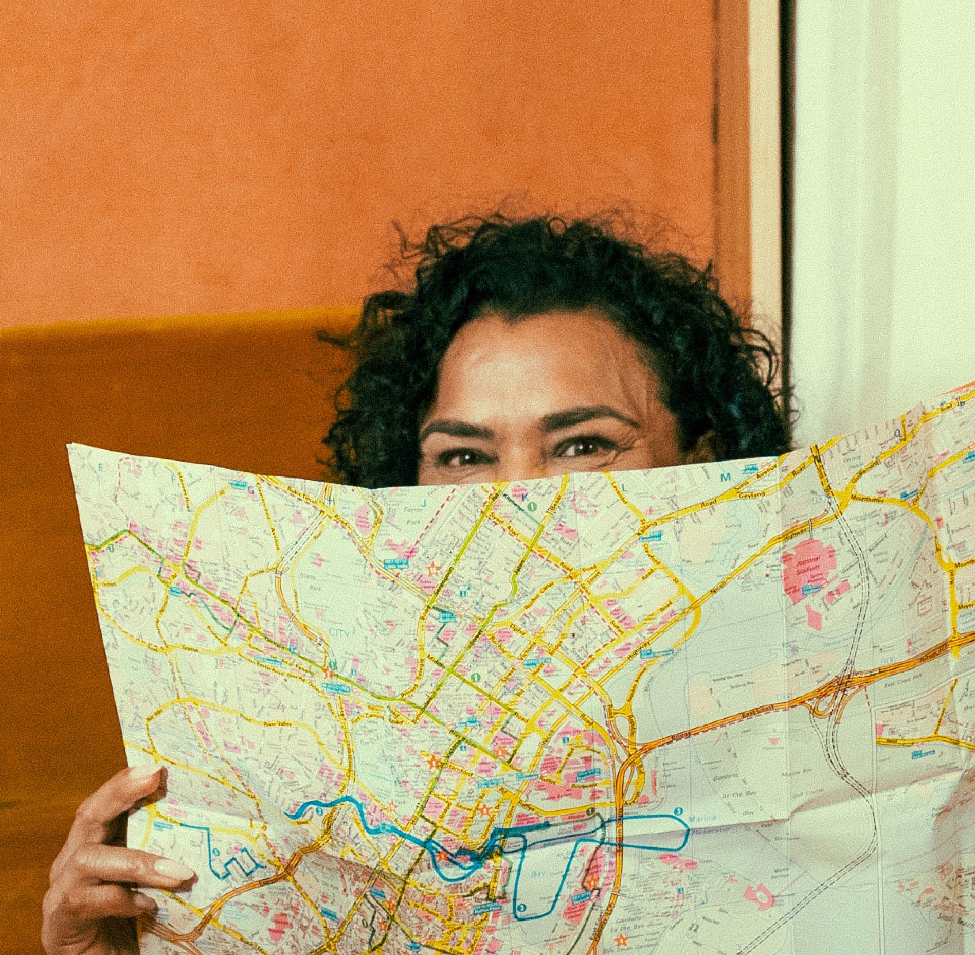 Woman looking at the camera while holding a map