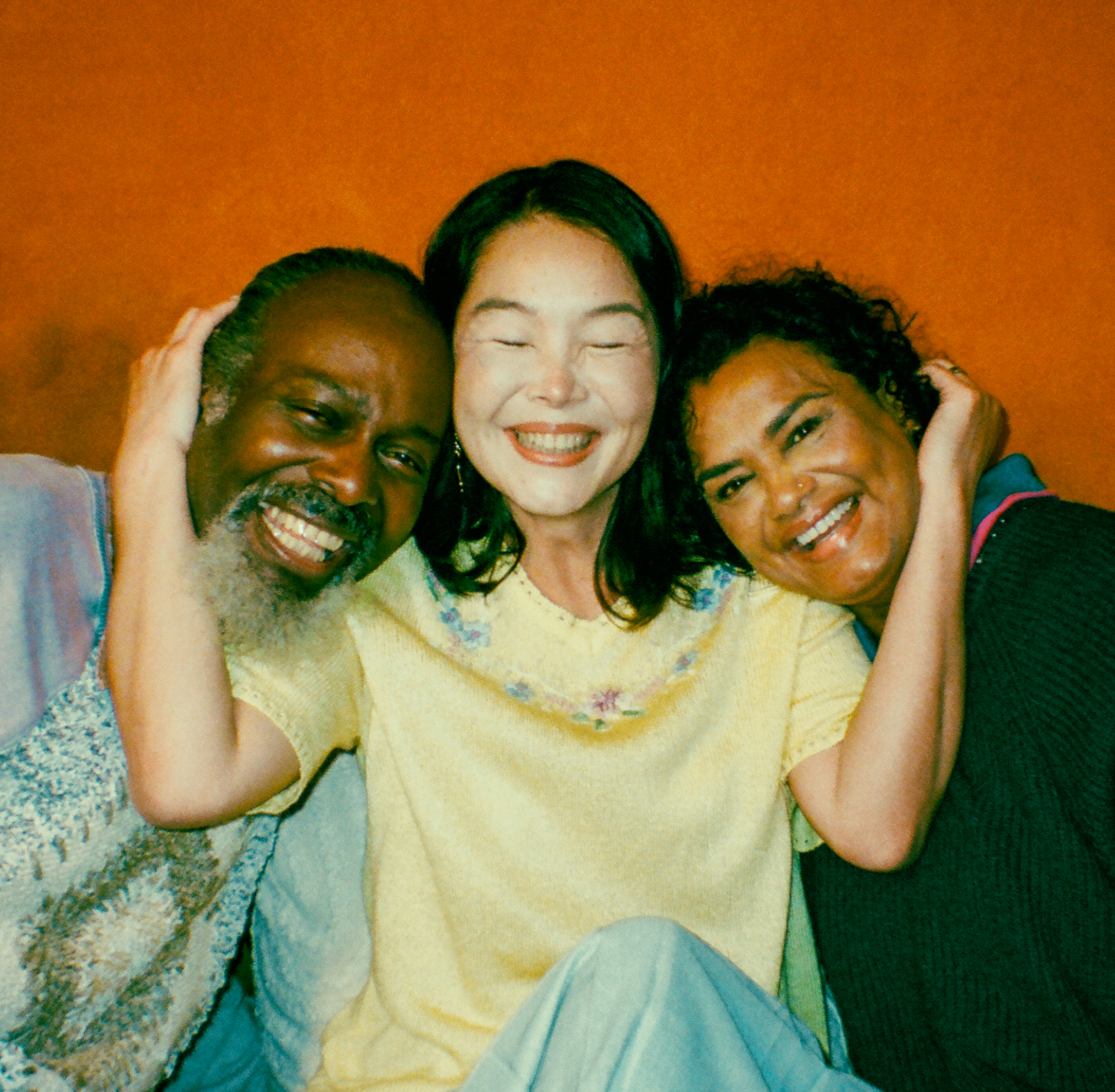 Three people smiling and posing to the camera