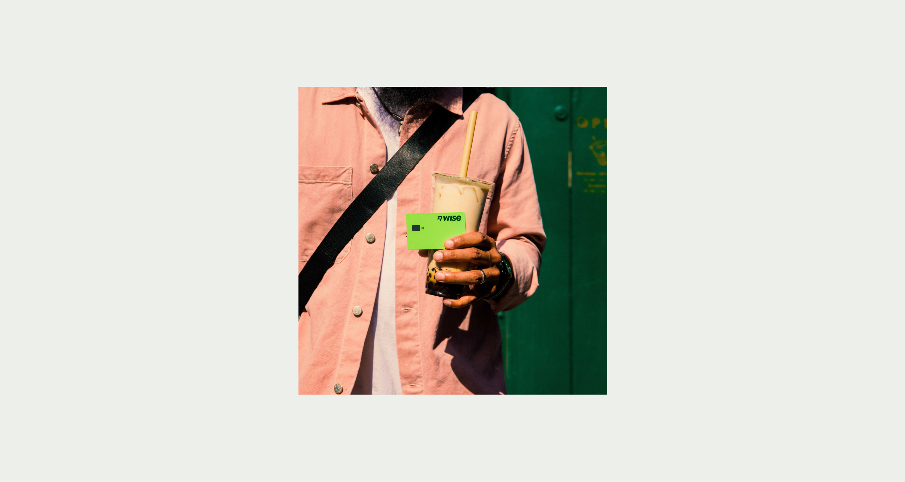 A customer holding a Wise card