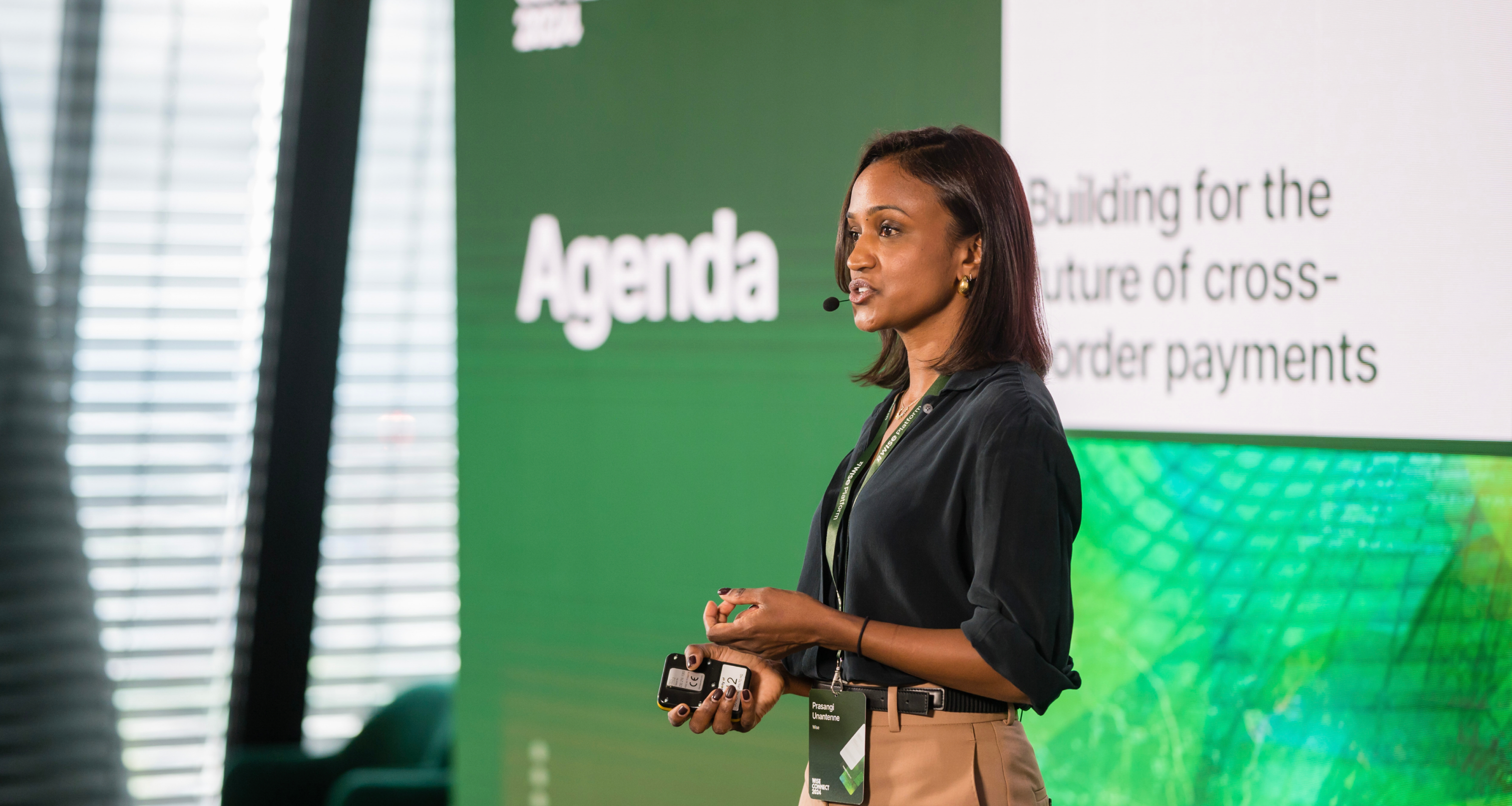 A woman presenting in front of a big screen with Wise Platform contents related